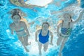 Family swims in pool under water, happy active mother and children have fun, fitness and sport with kids on vacation Royalty Free Stock Photo