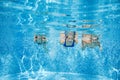 Family swims in pool under water, happy active mother and children have fun, fitness and sport with kids on summer vacation Royalty Free Stock Photo