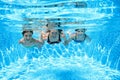 Family swims in pool under water, happy active mother and children have fun underwater, fitness and sport with kids on vacation