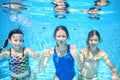 Family swims in pool underwater, happy active mother and children have fun under water, fitness and sport with kids Royalty Free Stock Photo