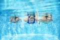 Family swims in pool underwater, happy active mother and children have fun under water, fitness and sport with kids Royalty Free Stock Photo