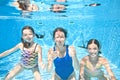 Family swims in swimming pool underwater, happy active mother and children have fun under water, fitness and sport with kids Royalty Free Stock Photo