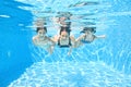 Family swims underwater in swimming pool, happy active mother and children have fun under water Royalty Free Stock Photo