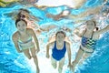 Family swims underwater in swimming pool, happy active mother and children have fun under water, fitness and sport with kids Royalty Free Stock Photo