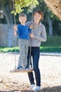 Family at swings Royalty Free Stock Photo