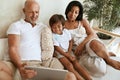 Family With Tablet Portrait. Interracial Parents Using Portable Digital Device Together.