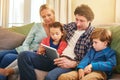 Family, tablet and together on couch for watching with happiness, internet connection and rapport. Parents, young