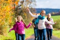 Family take walk in autumn forest flying kite Royalty Free Stock Photo