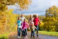 Family take a walk in autumn forest Royalty Free Stock Photo