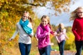 Family take a walk in autumn forest Royalty Free Stock Photo