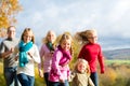 Family take a walk in autumn forest Royalty Free Stock Photo