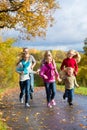 Family take a walk in autumn forest Royalty Free Stock Photo