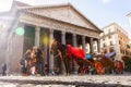 A family takes a selfie in front of the Pantheon in Rome