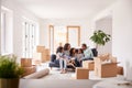 Family Taking A Break And Sitting On Sofa Celebrating Moving Into New Home Together Royalty Free Stock Photo