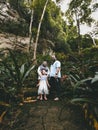 Family taking photo together in the rainforest jungle near Kelam cave