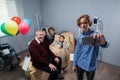 A family taking a selfie at the hospital room with a little cheerful girl lying in bed Royalty Free Stock Photo