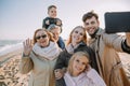 multigenerational family taking selfie on smartphone Royalty Free Stock Photo