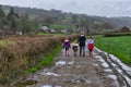 A family taking a walk along a road surrounded by farms and Welsh hills. Royalty Free Stock Photo