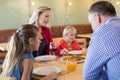 Family talking while enjoying appetizer in restaurant