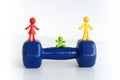 Family team concept with human miniature on dumbbell