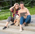 Shocked mother and daughter  using tablet PC outdoors in the par Royalty Free Stock Photo