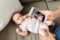 Father with smartphone taking picture baby at home Royalty Free Stock Photo