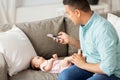 Father with smartphone taking picture baby at home Royalty Free Stock Photo