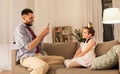 Father photographing daughter by cellphone at home