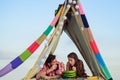 Family in tent. Couple in love hugging and kissing in camping. Smoking man eating woman at picnic outdoor. Royalty Free Stock Photo