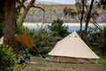 Family tent setup at the campsite surrounding by bush forest near the ocean bay in Australia. Family vacation travel camping