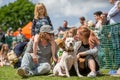 A family with their dog in the park at a dog show