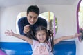 Family in theme park. Father and girl in an amusement park. Father and daughter looking camera near carousel in amusement park Royalty Free Stock Photo