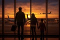 Family of three, captivated by vibrant sunset, watch planes take off at bustling airport terminal