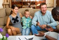 Family of three communicates with social worker in home interior Royalty Free Stock Photo