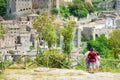 Family of three enjoying the view of Sorano, an ancient medieval hill town hanging from a tuff stone over the Lente River