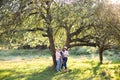 Family of three generation women, spending time together in green summer garden, posing under the big tree Royalty Free Stock Photo