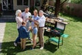 Family of three generations clinking glasses while making barbecue Royalty Free Stock Photo