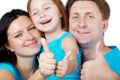 Family of three gives their thumbs up