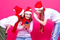 Holidays Concepts. Family of Three Happy Caucasian Girls Wearing Santa Hats Having Fun Together With New Year Presents Gifts Royalty Free Stock Photo