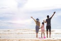 Family of three having fun on the beach