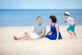 Family of three having fun on tropical beach Royalty Free Stock Photo