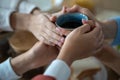 Family holding cup of tea in hands, warming in cold apartment