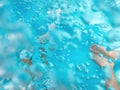 Family of three in hot tub, underwater shot of legs in bubbly pool water Royalty Free Stock Photo