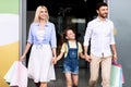 Family Of Three Leaving Shopping Mall Carrying Bags Royalty Free Stock Photo