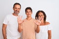 Family of three, mother, father and son standing over white isolated background showing and pointing up with fingers number ten Royalty Free Stock Photo