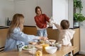 Family of three mother and kids eating cereals with milk for breakfast Royalty Free Stock Photo