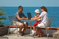 Family of three people resting on sea