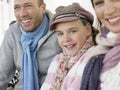 Family Of Three Sitting Side By Side