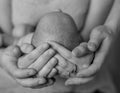 Family of three together, parents holding head of their first child