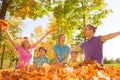 Family throwing leaves in the air during play Royalty Free Stock Photo